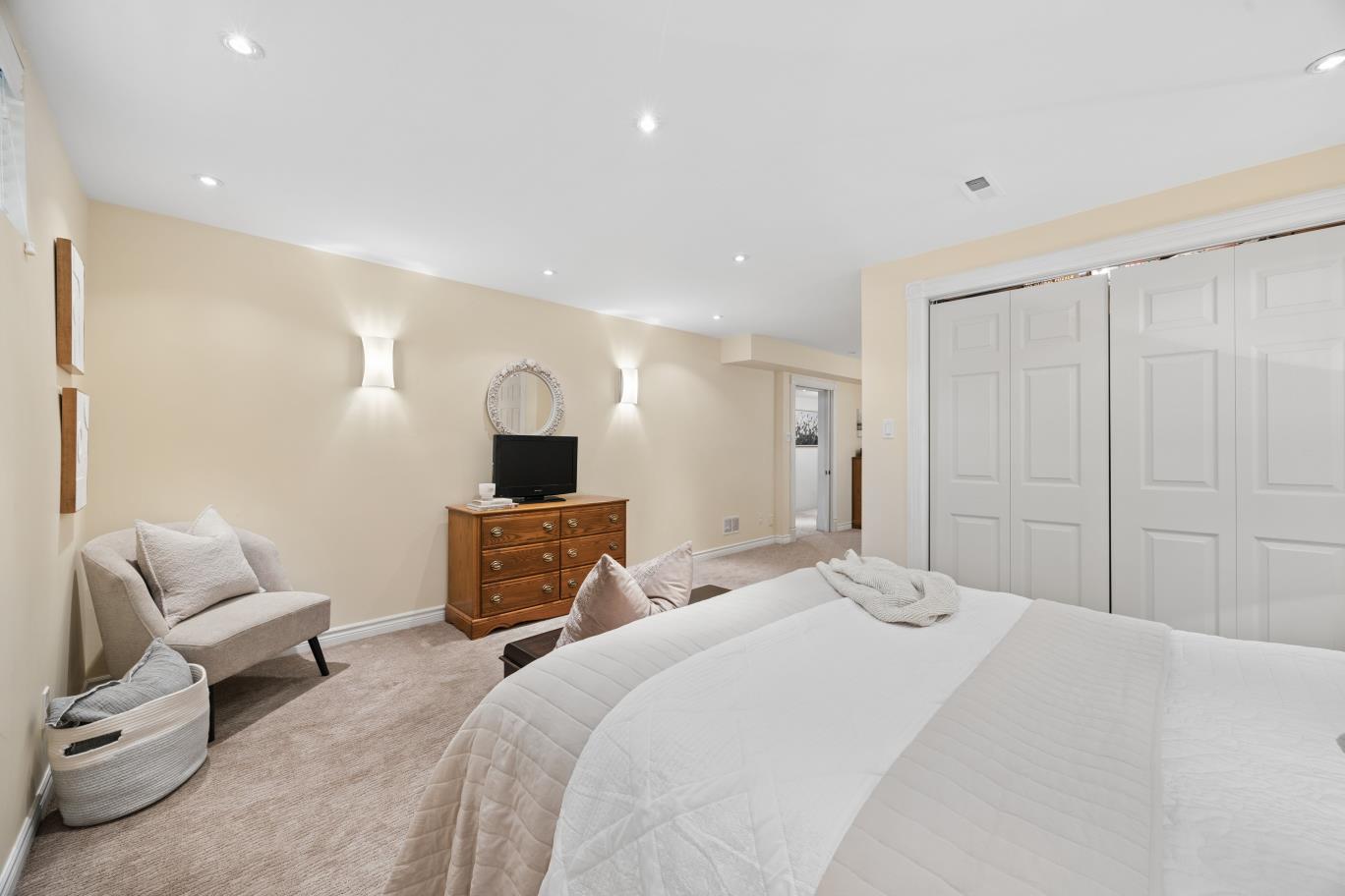 Basement guest bedroom with dresser and closet at 30 Potters Lane