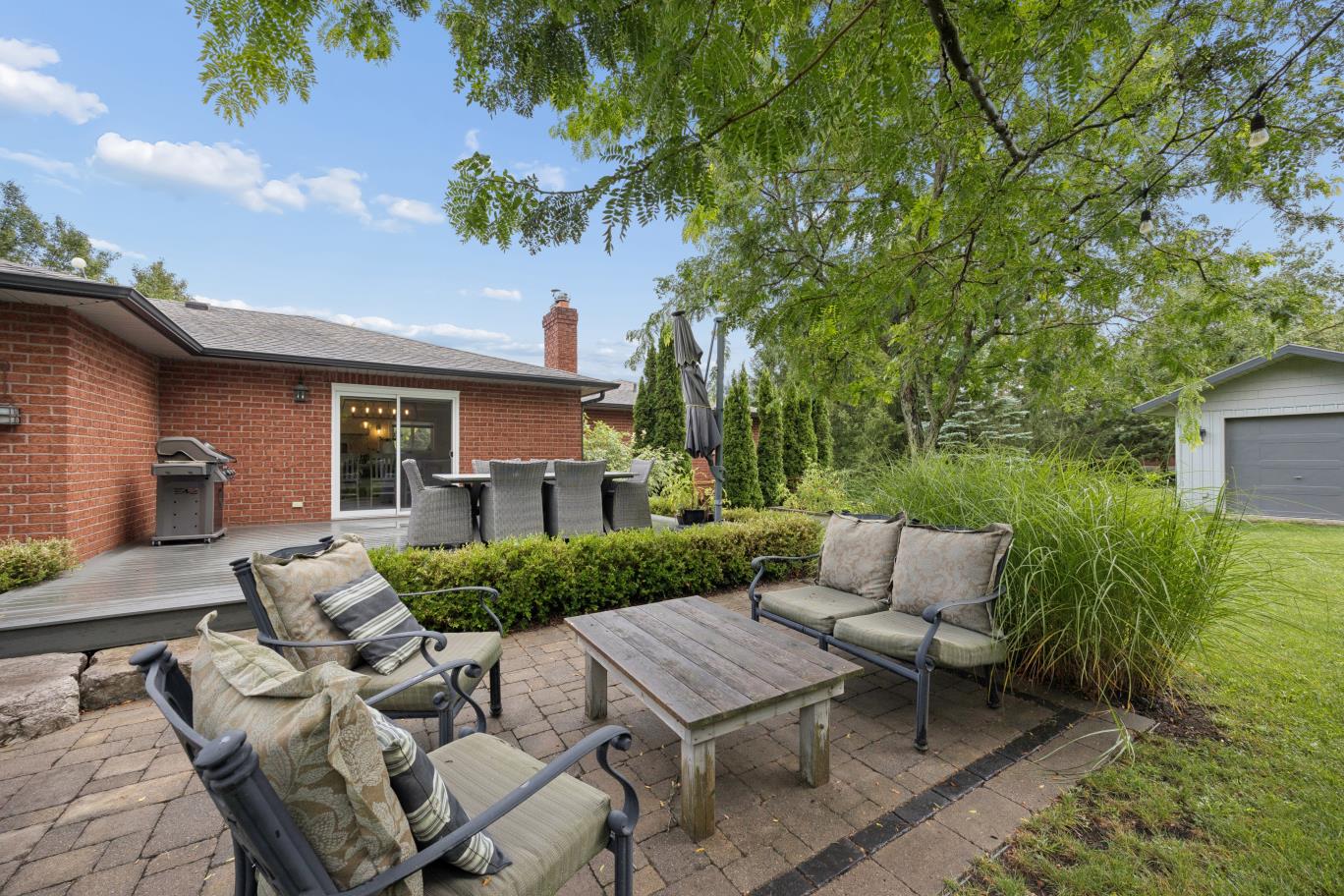 Raised deck and lower stone patio outdoor living at 30 Potters Lane, Clarington